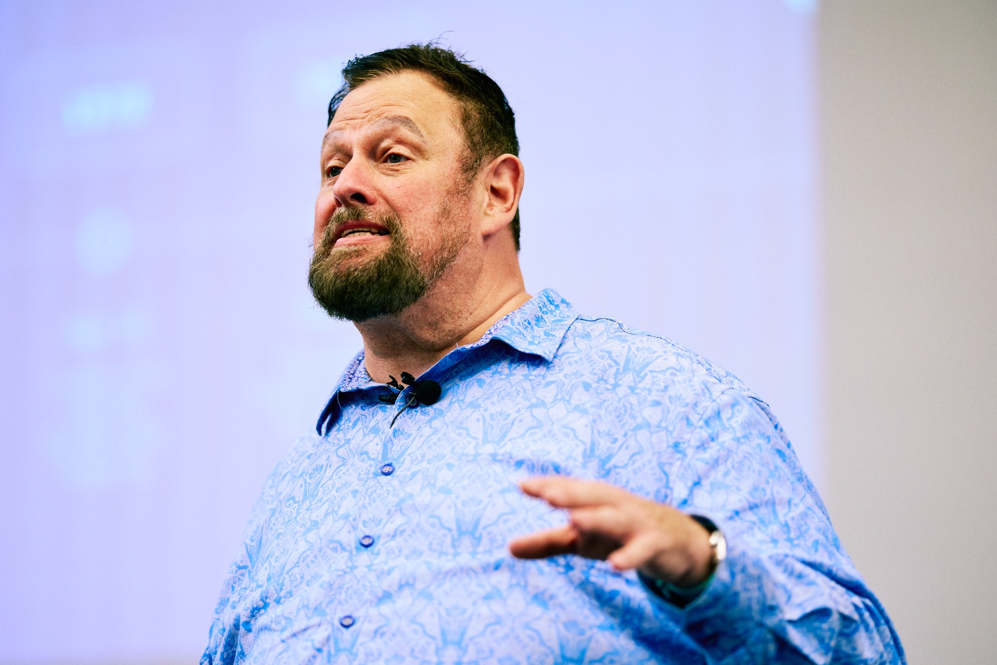 Wally Bressler speaking with expressive hand gestures